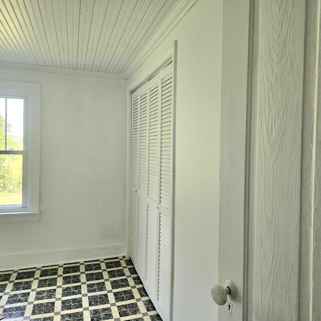 interior space featuring tile patterned flooring and wooden ceiling