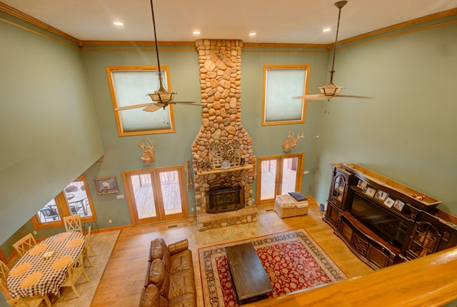 living room with ceiling fan, light hardwood / wood-style floors, and a healthy amount of sunlight