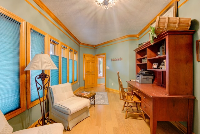 home office with light wood-type flooring, a textured ceiling, and ornamental molding