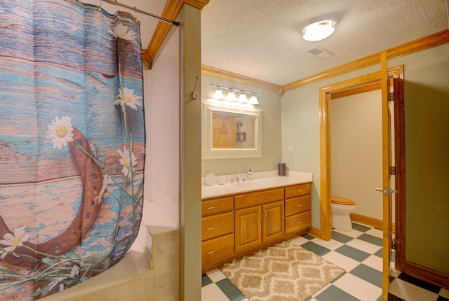 bathroom featuring toilet, tile patterned flooring, vanity, ornamental molding, and a textured ceiling