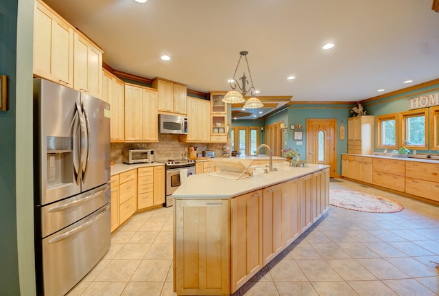 kitchen featuring backsplash, an island with sink, light brown cabinetry, stainless steel appliances, and pendant lighting