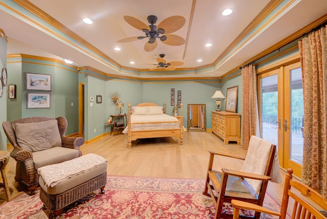 bedroom with light hardwood / wood-style flooring, french doors, a tray ceiling, access to exterior, and crown molding