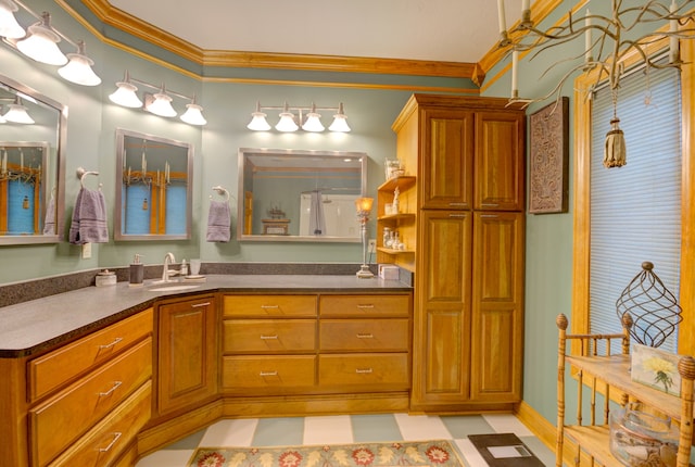 bathroom with tile patterned flooring, ornamental molding, and vanity