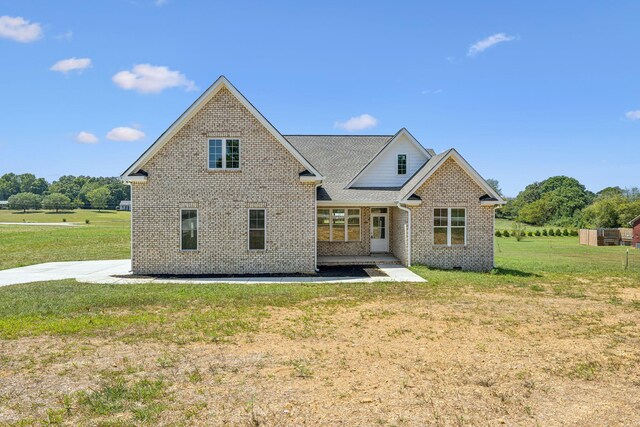 rear view of house featuring a lawn