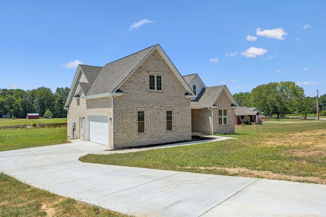 view of side of home featuring a lawn and a garage