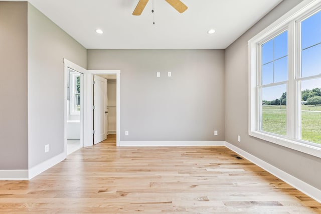 unfurnished room featuring light wood-style floors, baseboards, and recessed lighting