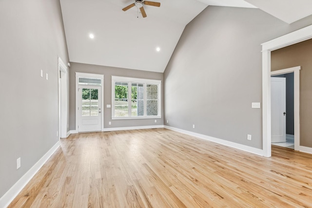 unfurnished living room featuring high vaulted ceiling, light wood-style floors, baseboards, and ceiling fan