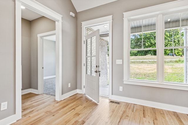 entryway featuring light hardwood / wood-style floors, plenty of natural light, and lofted ceiling