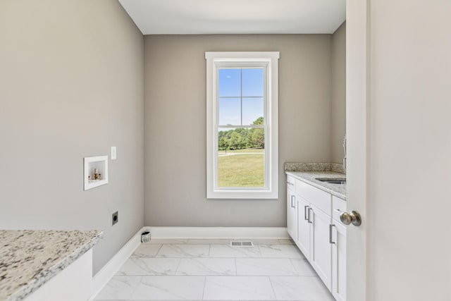 washroom featuring cabinet space, visible vents, marble finish floor, washer hookup, and electric dryer hookup