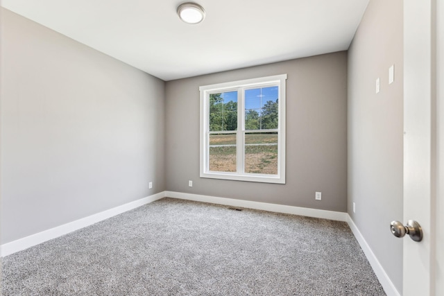 spare room with carpet flooring and baseboards