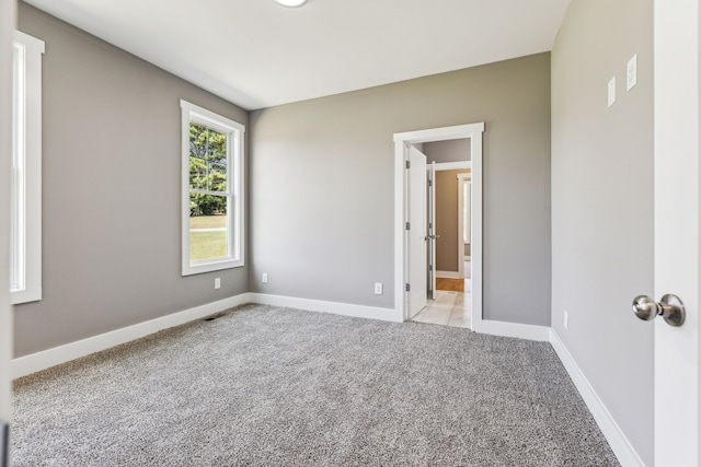 empty room featuring light carpet