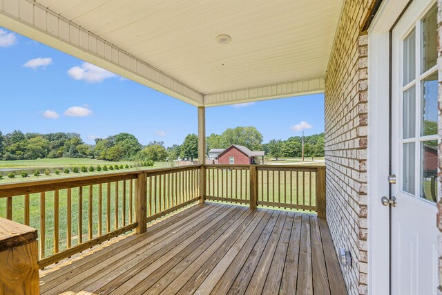 wooden terrace with a yard