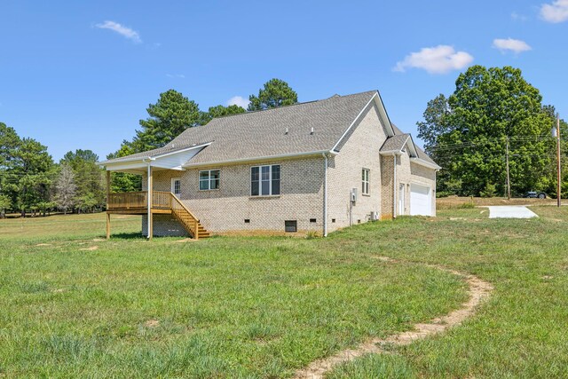 rear view of property featuring a lawn and a wooden deck