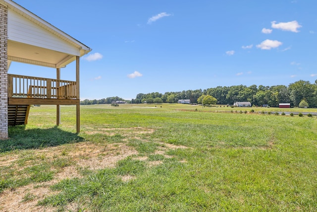 view of yard with a rural view and a deck