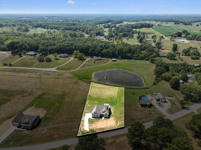 birds eye view of property with a rural view