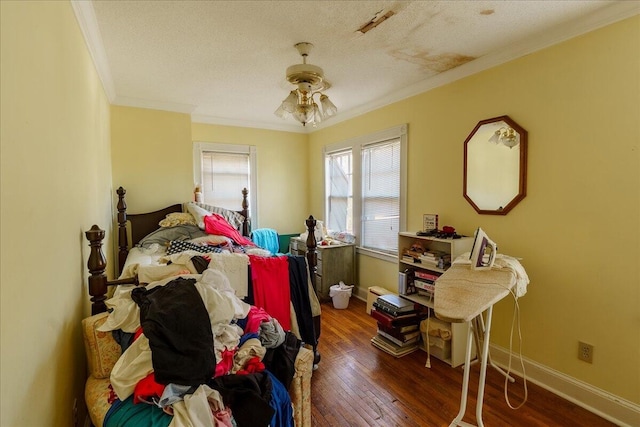 bedroom with a textured ceiling, ceiling fan, hardwood / wood-style floors, and crown molding