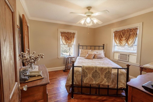 bedroom with ornamental molding, cooling unit, a textured ceiling, dark wood-type flooring, and ceiling fan