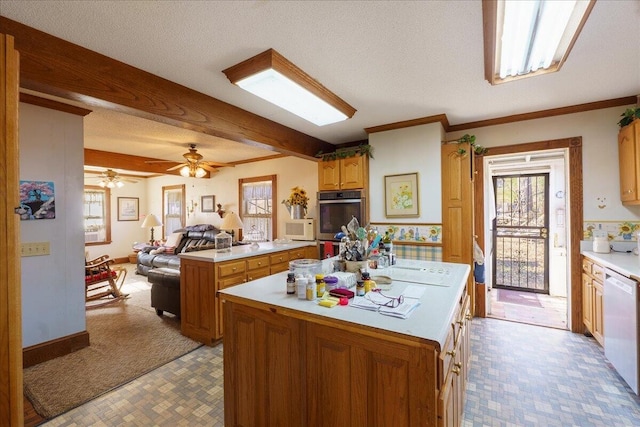 kitchen featuring white appliances, a center island, and plenty of natural light