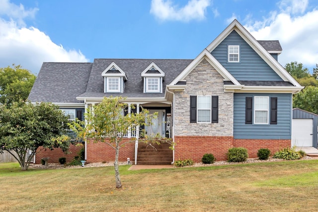 view of front of home featuring a garage, a front lawn, and an outdoor structure