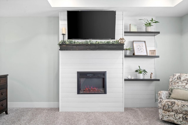 carpeted living room with a large fireplace