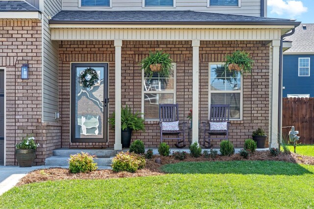 doorway to property with a lawn