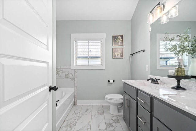 bathroom featuring a tub to relax in, toilet, and vanity