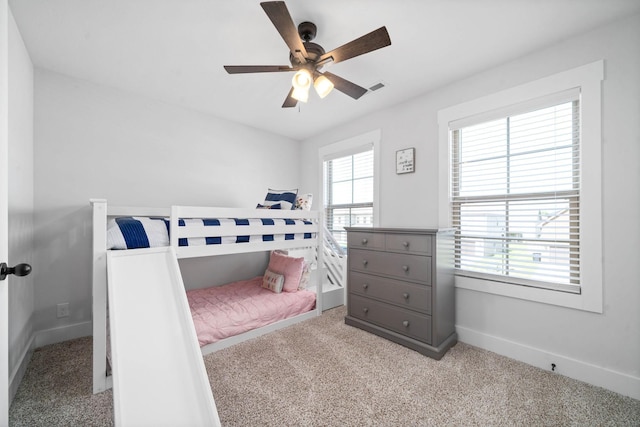 bedroom with ceiling fan and light carpet