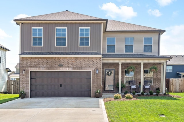 view of front of property with a front lawn, a garage, and a porch