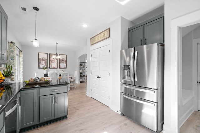 kitchen featuring a chandelier, light wood-type flooring, gray cabinetry, stainless steel fridge with ice dispenser, and hanging light fixtures