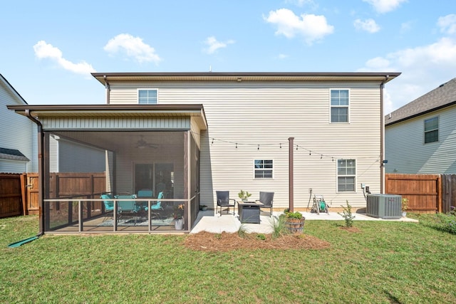 back of house featuring cooling unit, a patio, a sunroom, and a lawn