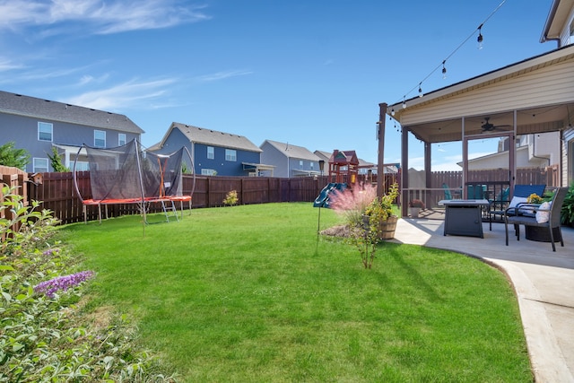 view of yard featuring a playground, a patio area, and a trampoline