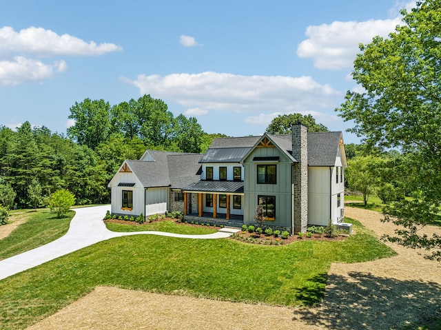 modern inspired farmhouse with a front lawn