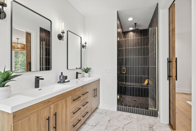 bathroom featuring wood-type flooring, a shower with door, and double sink vanity