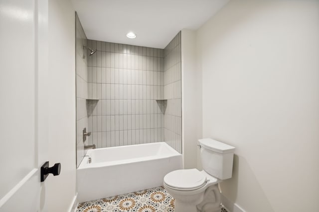 bathroom featuring toilet and tiled shower / bath combo