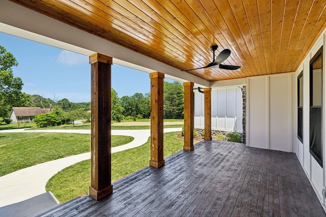 unfurnished sunroom featuring ceiling fan and wooden ceiling