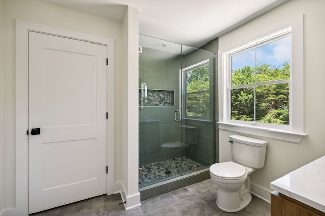 bathroom featuring vanity, toilet, walk in shower, and tile patterned floors