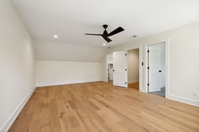 unfurnished bedroom featuring lofted ceiling, light hardwood / wood-style flooring, and ceiling fan