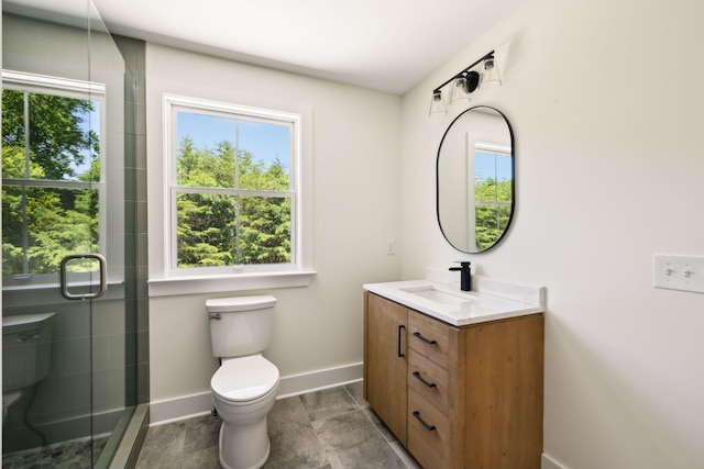 bathroom with tile patterned flooring, vanity, toilet, and a wealth of natural light