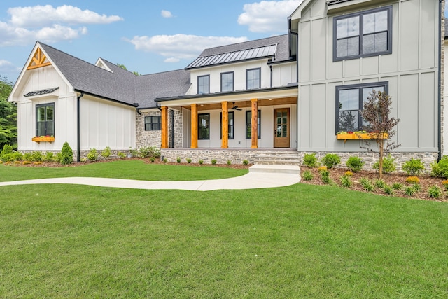 modern farmhouse with a front lawn and a porch