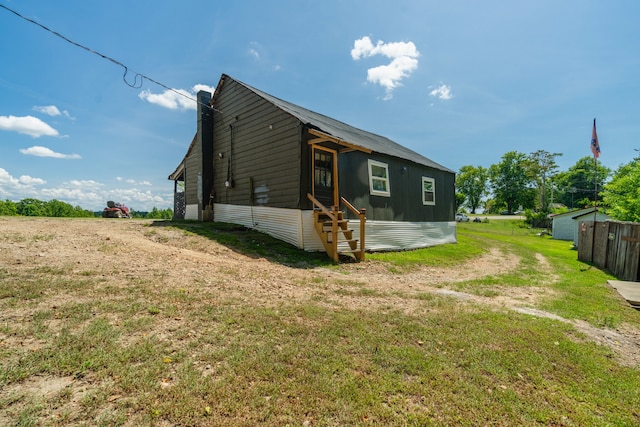 back of property with a lawn