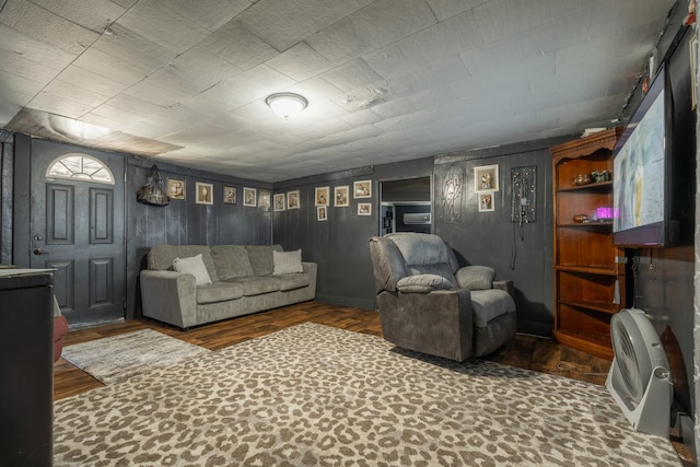 living room featuring dark hardwood / wood-style flooring and built in shelves