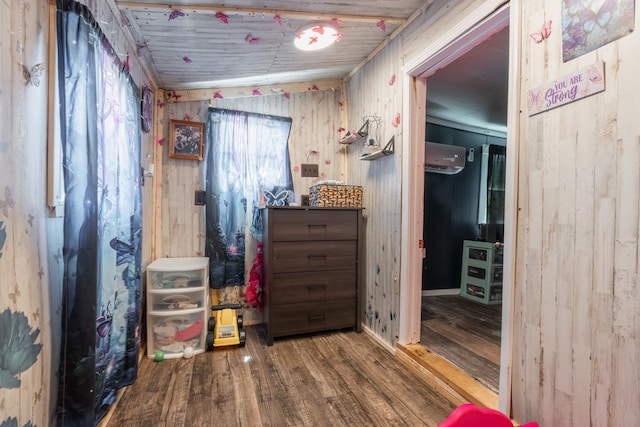 interior space featuring hardwood / wood-style flooring, a wall mounted AC, wood walls, and wooden ceiling