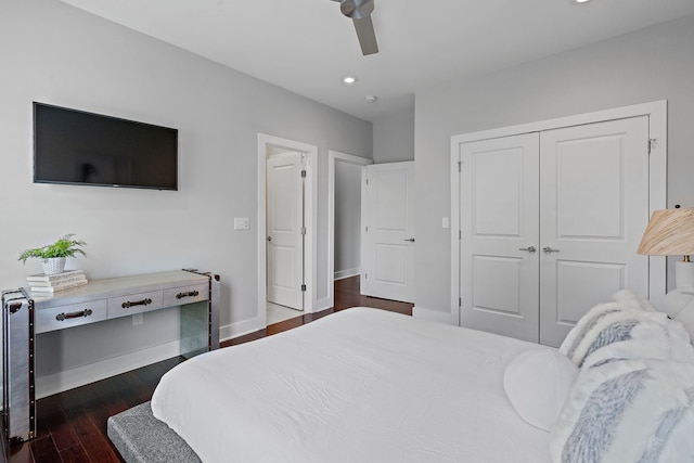 bedroom featuring ceiling fan, a closet, and dark wood-type flooring