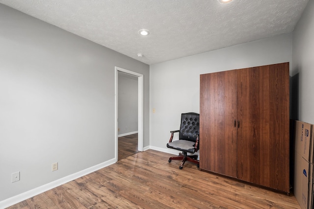 office featuring hardwood / wood-style flooring and a textured ceiling