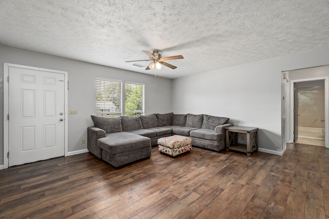 living room with a textured ceiling, ceiling fan, and hardwood / wood-style flooring