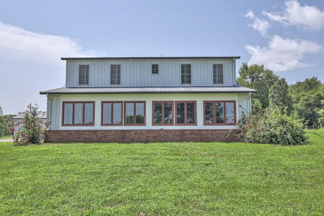 rear view of property featuring a yard