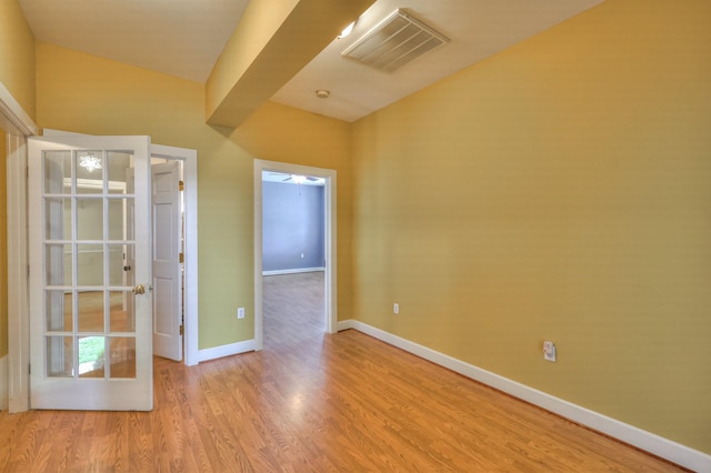 unfurnished room with light hardwood / wood-style floors