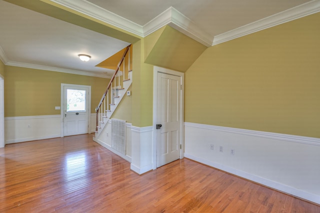 entrance foyer with crown molding and wood-type flooring