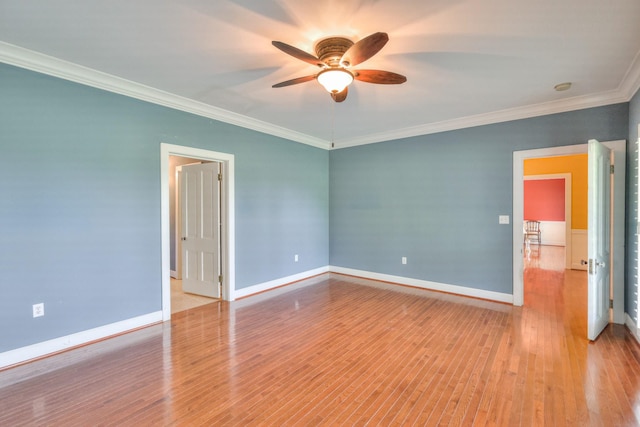 spare room with ceiling fan, ornamental molding, and light wood-type flooring