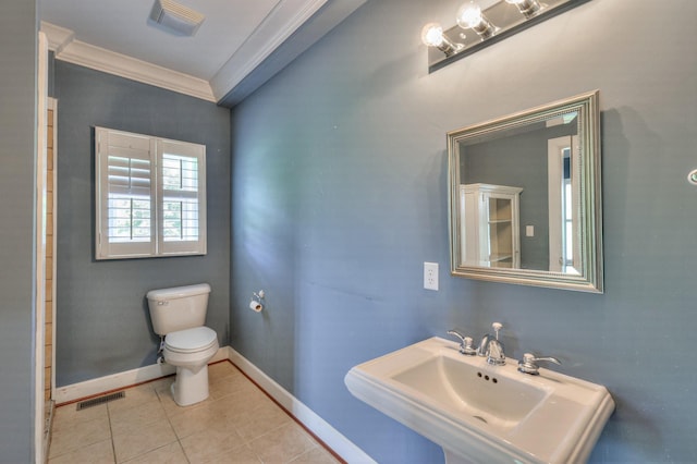 bathroom with tile patterned floors, crown molding, toilet, and sink